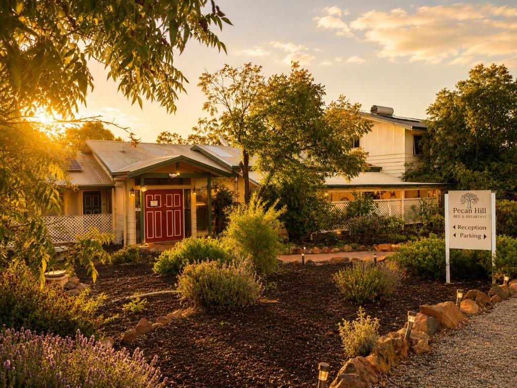 a house with a sign in front of a yard at Pecan Hill BNB in Toodyay