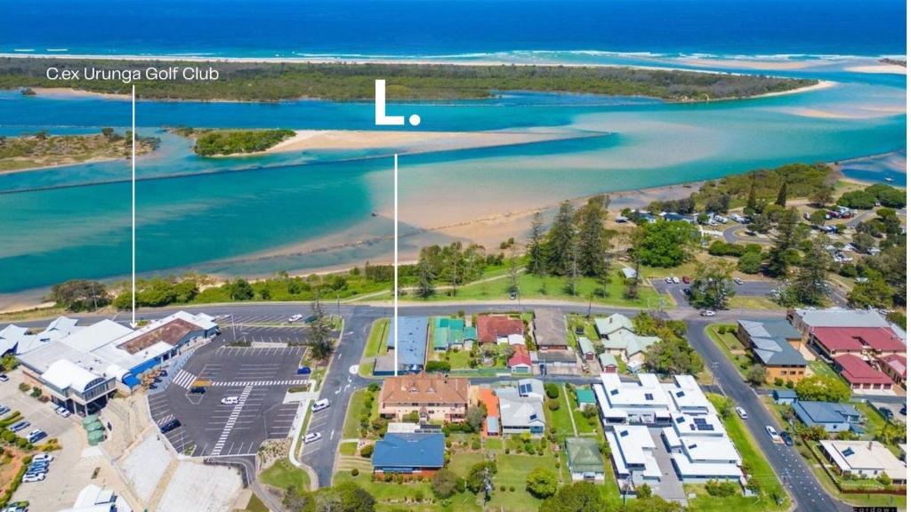 an aerial view of a city with a beach at North Street Panorama in Urunga