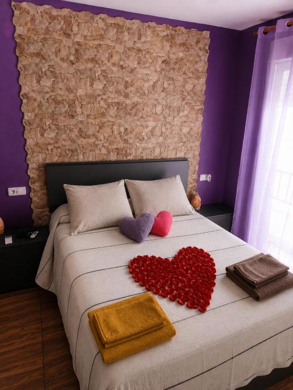 a bedroom with a bed with two hearts on it at Romantic - Garaje Incluido & ApartamentosAltea in Altea