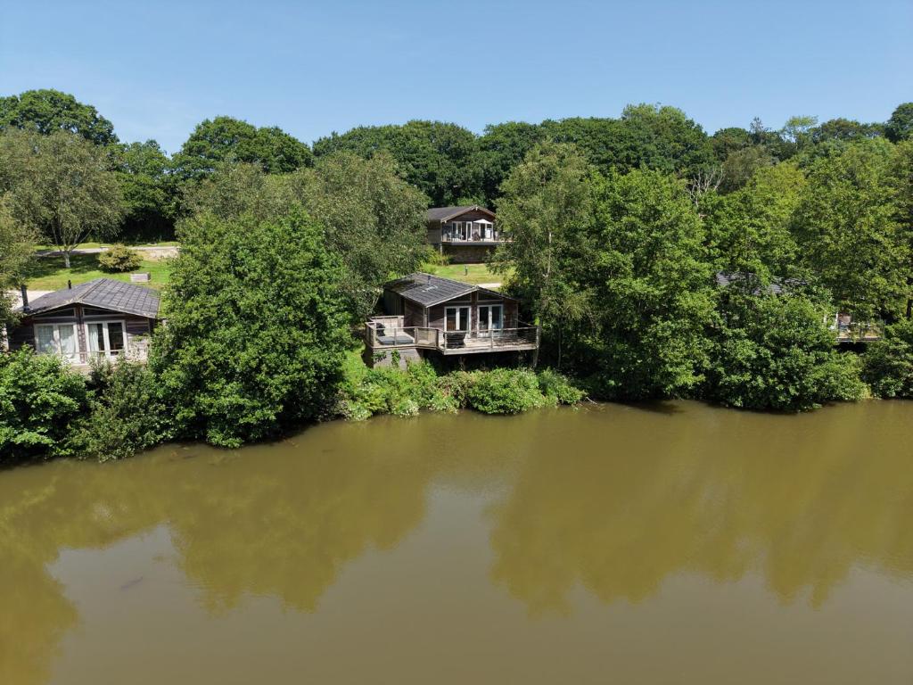 an aerial view of a house on the banks of a river at 4 Water's Edge in Looe