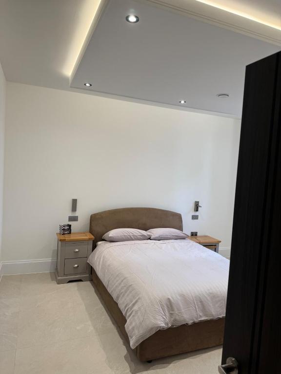 a bedroom with a bed with a white ceiling at The Apse in Stotfold