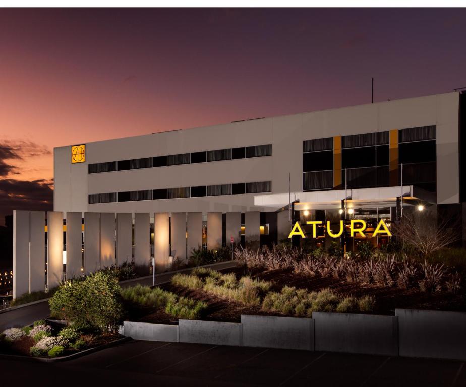 an office building with aania sign on it at night at Atura Dandenong in Dandenong
