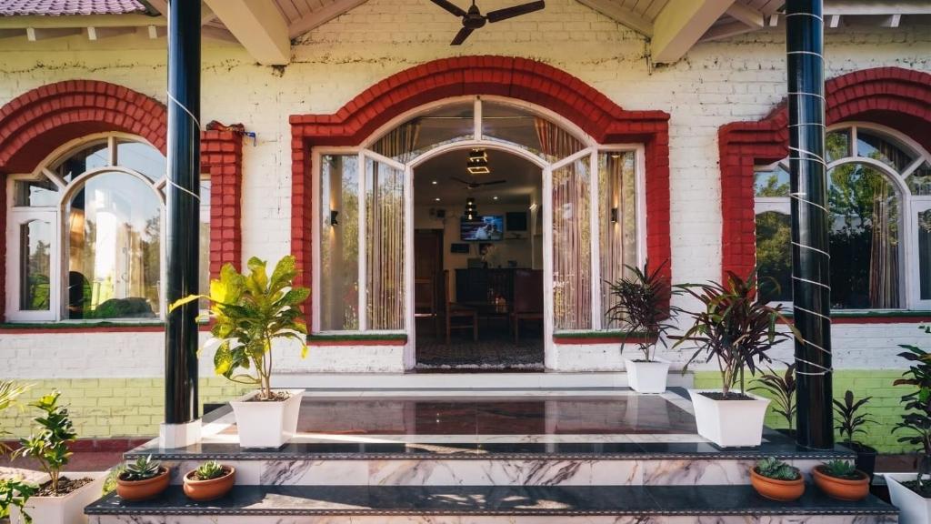 an entrance to a house with potted plants in front at Hariparbatview in Srinagar