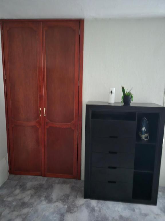 a room with a dresser and a wooden cabinet at Studio 40 in Tequila