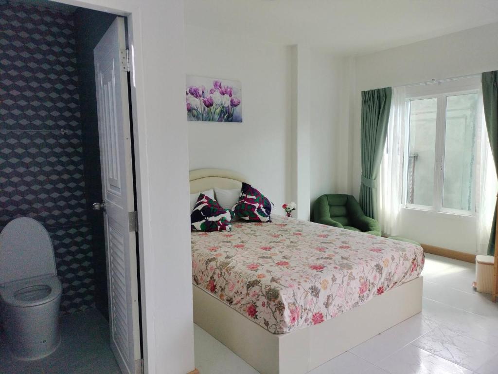 a bedroom with a bed and a window at Aysaii Home01 in Panwa Beach