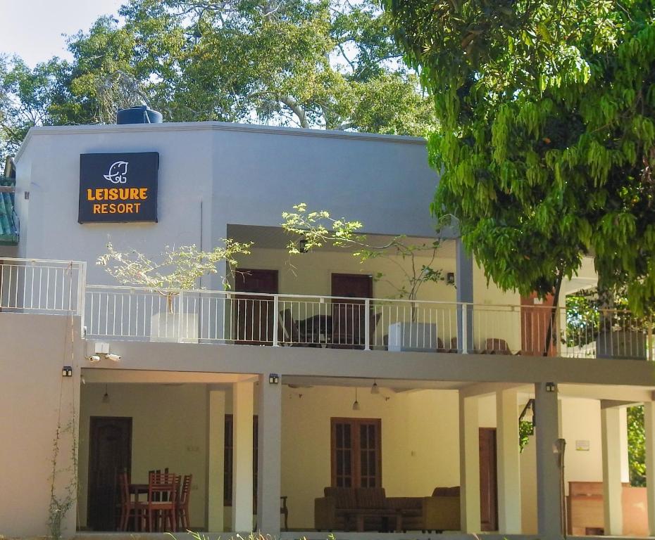 a white building with a sign that reads leisure resort at Wilpattu Corridor Leisure in Wilpattu