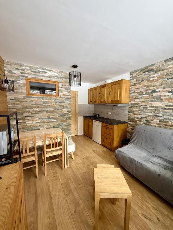a living room with a bed and a table and a kitchen at Welcome to Star Vars! in Vars