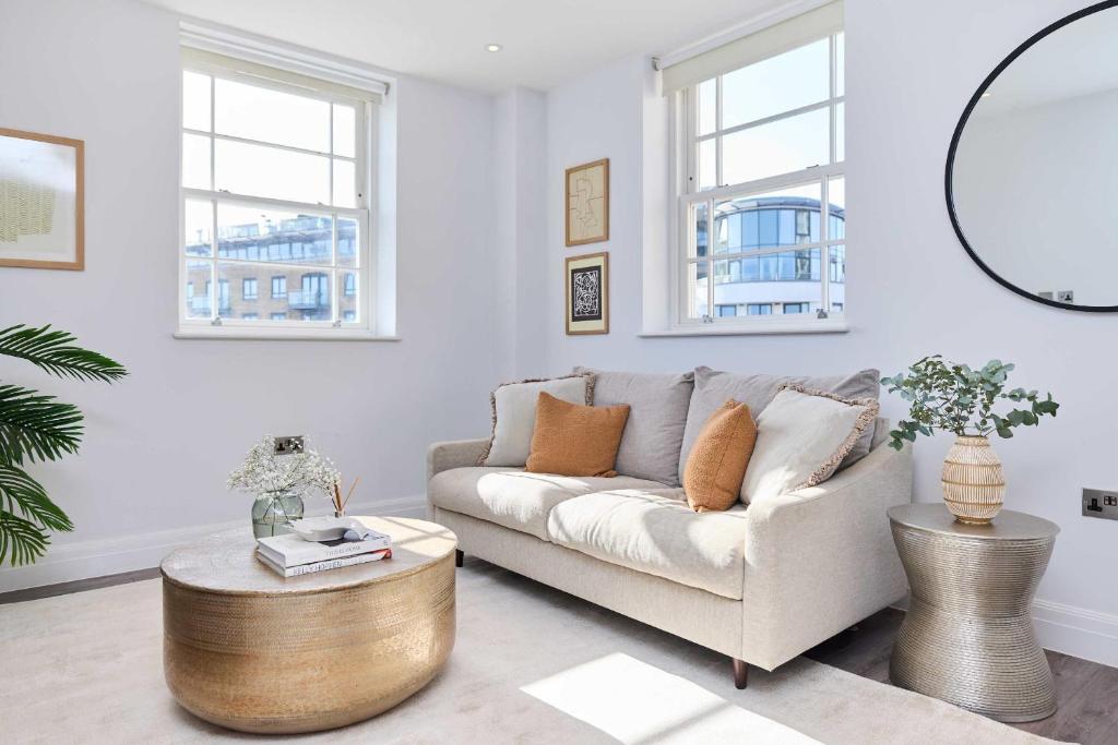 a living room with a couch and a table at Second Storey at Kew in Kew Bridge