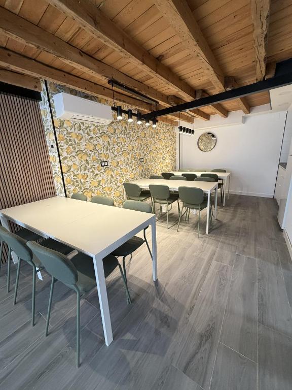 a row of tables and chairs in a room at Albergue -Hostel ManuelaINN in El Burgo de Osma