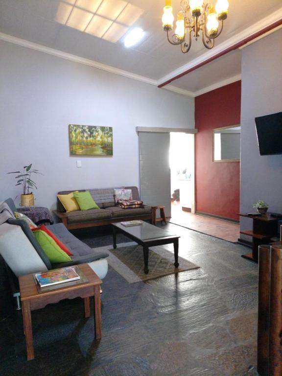 a living room with a couch and a table at Karee Laagte in Leeuwfontein