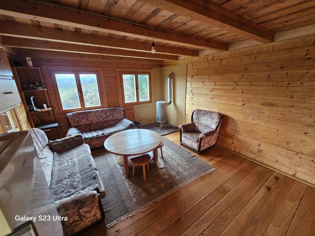 a living room with a table and chairs at Ранч ДИМ in Ivanjica