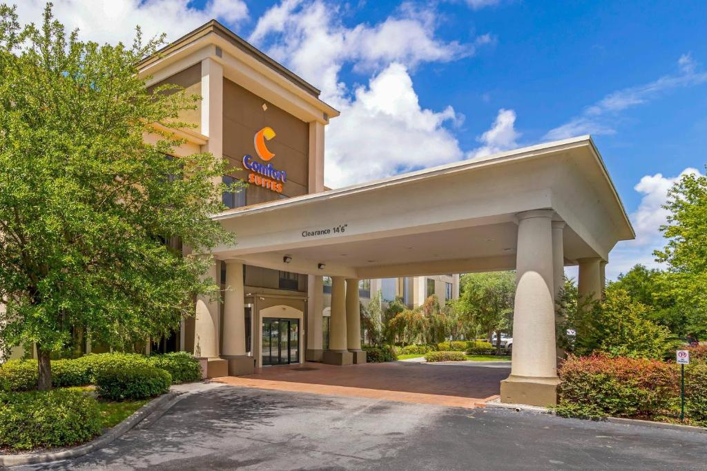 a hotel with a sign on the front of a building at Comfort Suites near MCAS Beaufort in Beaufort