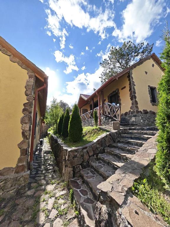 a stone stairway leading to a house with a building at LerHouseDilijan in Dilijan