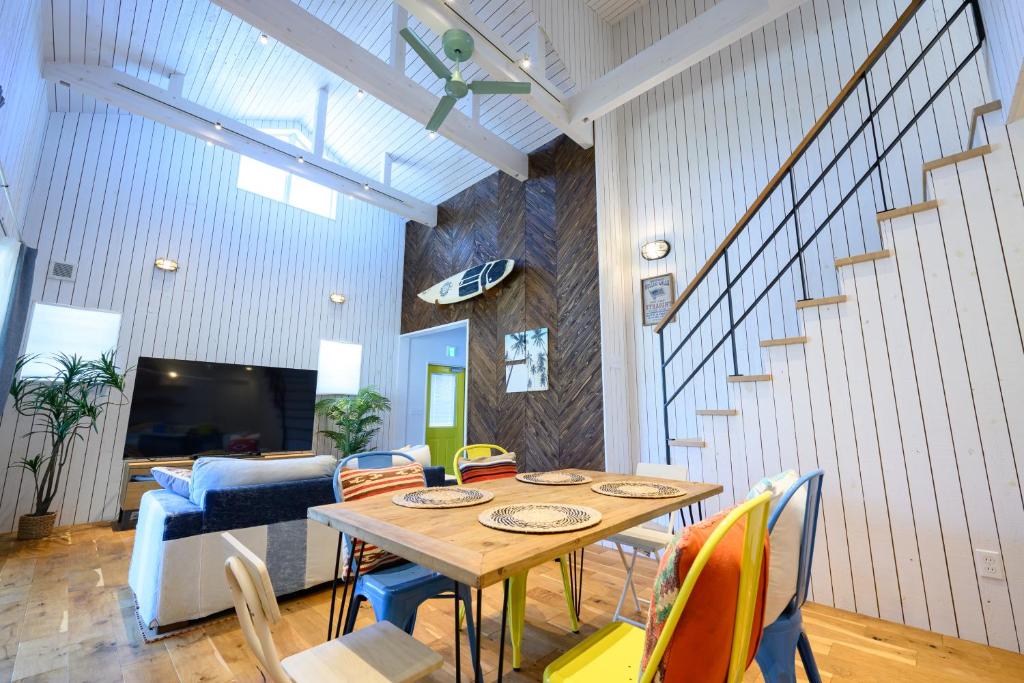 a dining room with a table and chairs at Aoshima Surfers House in Miyazaki