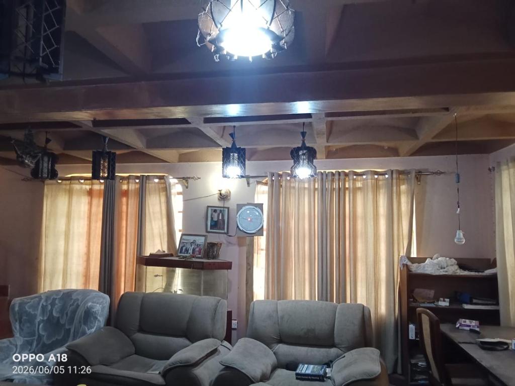 a living room with two chairs and a couch at WANDA's in Makandara