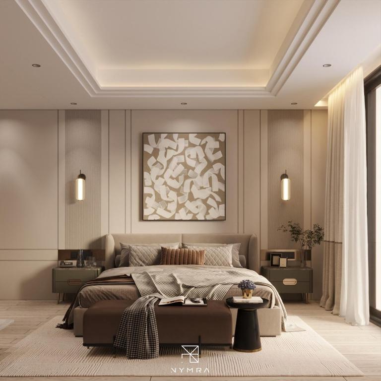 a bedroom with a large bed and a painting on the wall at Ananta Elite in Somnath