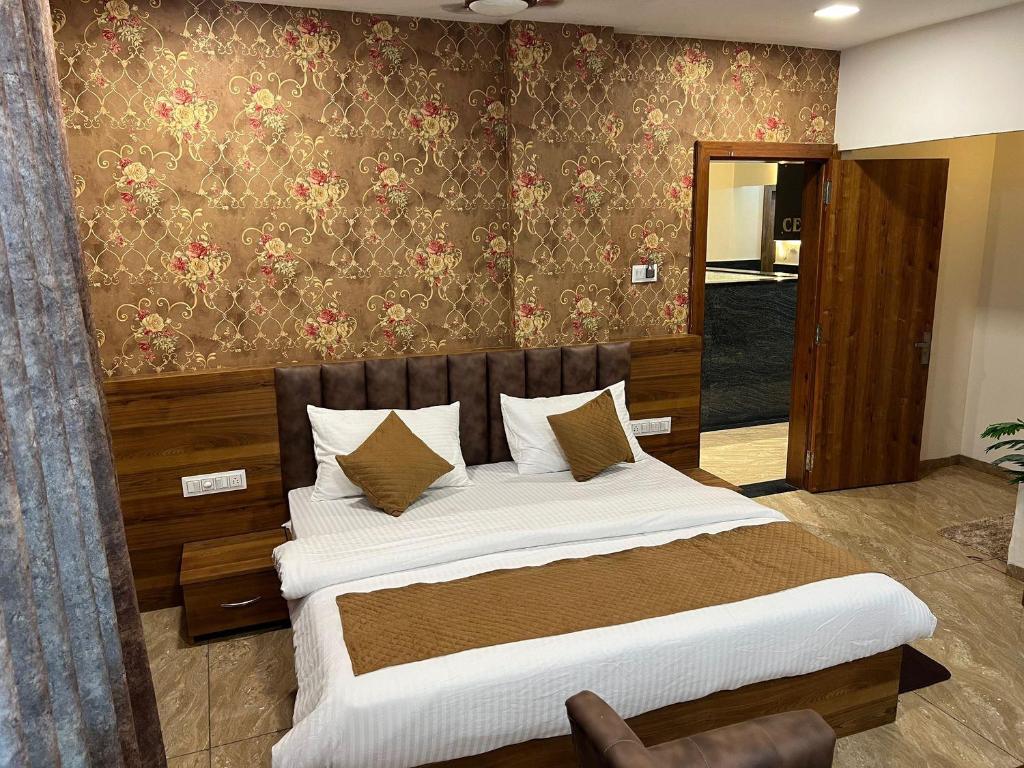 a bedroom with a large bed in a room at Hotel Central Point in Indore