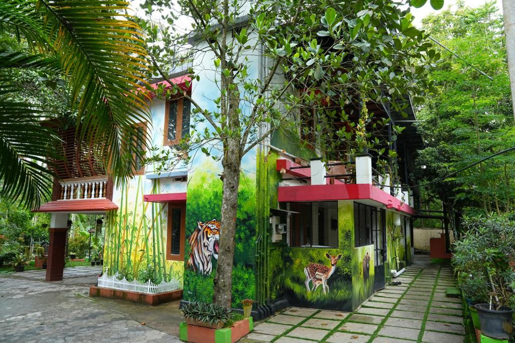 a building with a tiger painted on the side of it at Kaivalyam Homestay in Wayanad