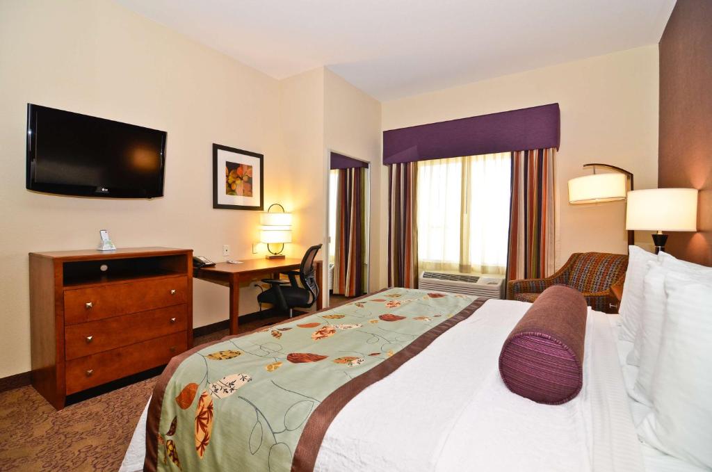 a hotel room with a bed and a desk at Best Western Plus Carousel Inn & Suites Burlington in Burlington