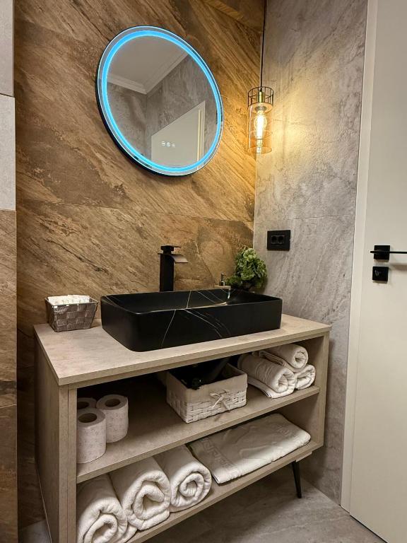 a bathroom with a black sink and a mirror at Noble Stay in Saturn