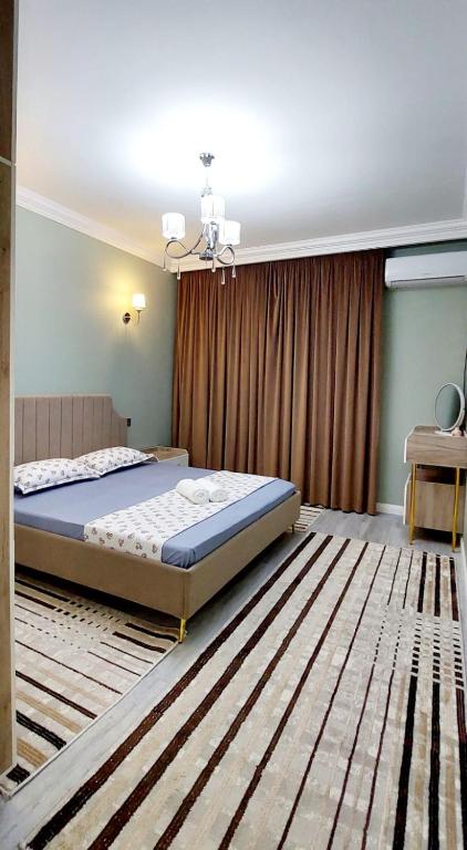 a bedroom with a large bed in a room at Яншина 2 in Qyzylorda