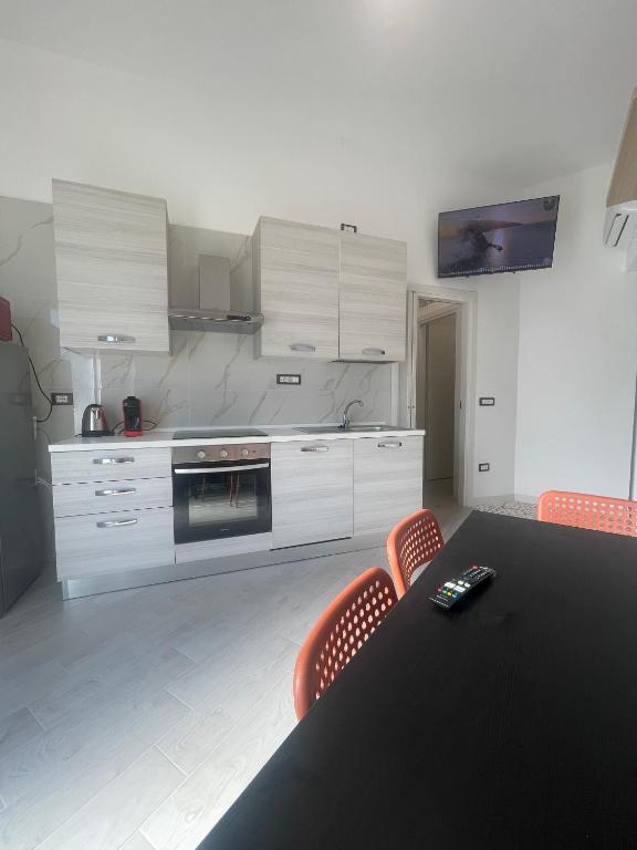 a kitchen with a black table and orange chairs at Casa Vacanze Nautilus in Termoli