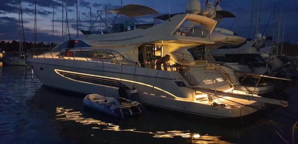 a large white boat in the water at night at Houseboat Dolce Vita in Novigrad Istria