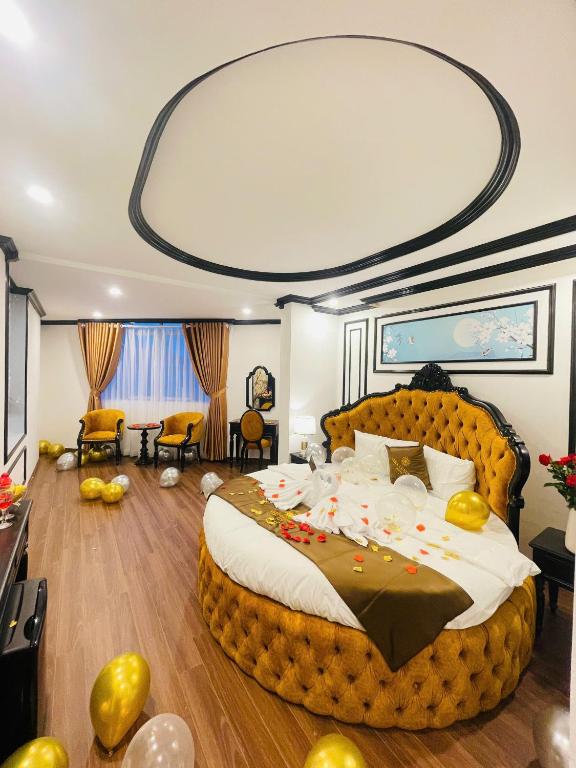 a bedroom with a large bed in a room with a large bed sqor at Vera Luxury Hotel in Hanoi