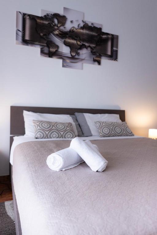 a roll of paper towels sitting on a bed at House Santa Rita in Turin