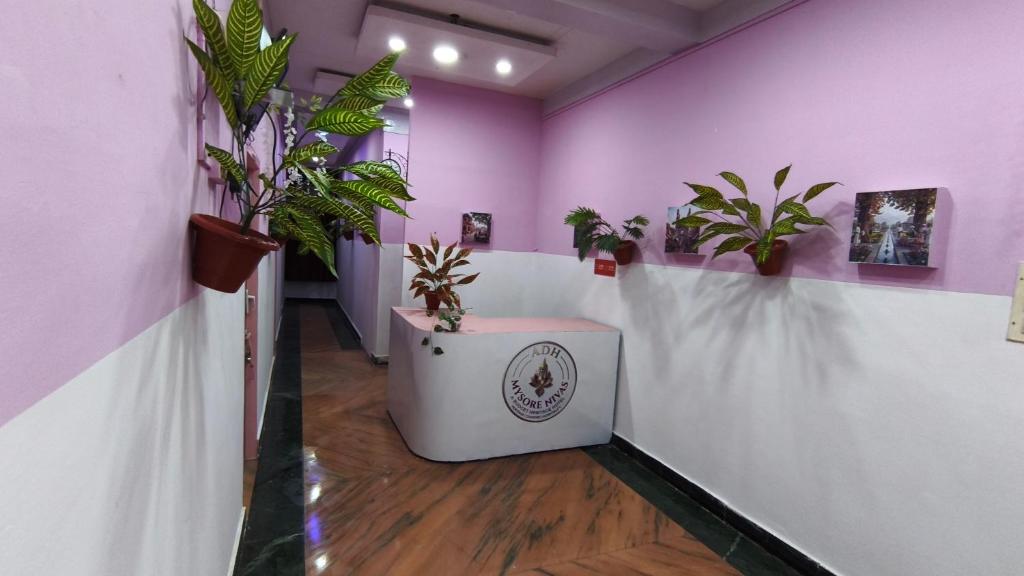 a room with potted plants on a wall at Mysore Nivas - ADH in Mysore