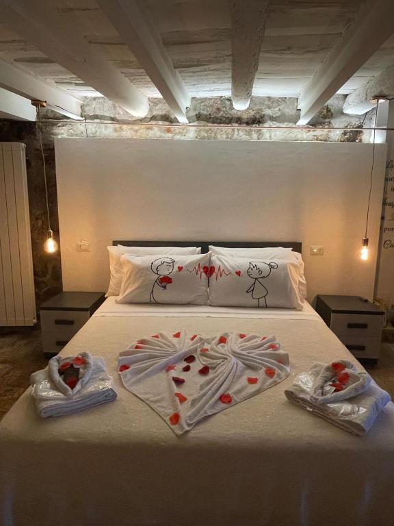 a bedroom with a bed with hearts on the sheets at La casetta di Giogi in Sutri