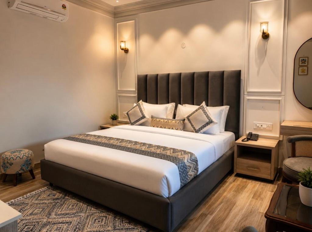 a bedroom with a large bed with a black headboard at Elegance Regency in Khanna