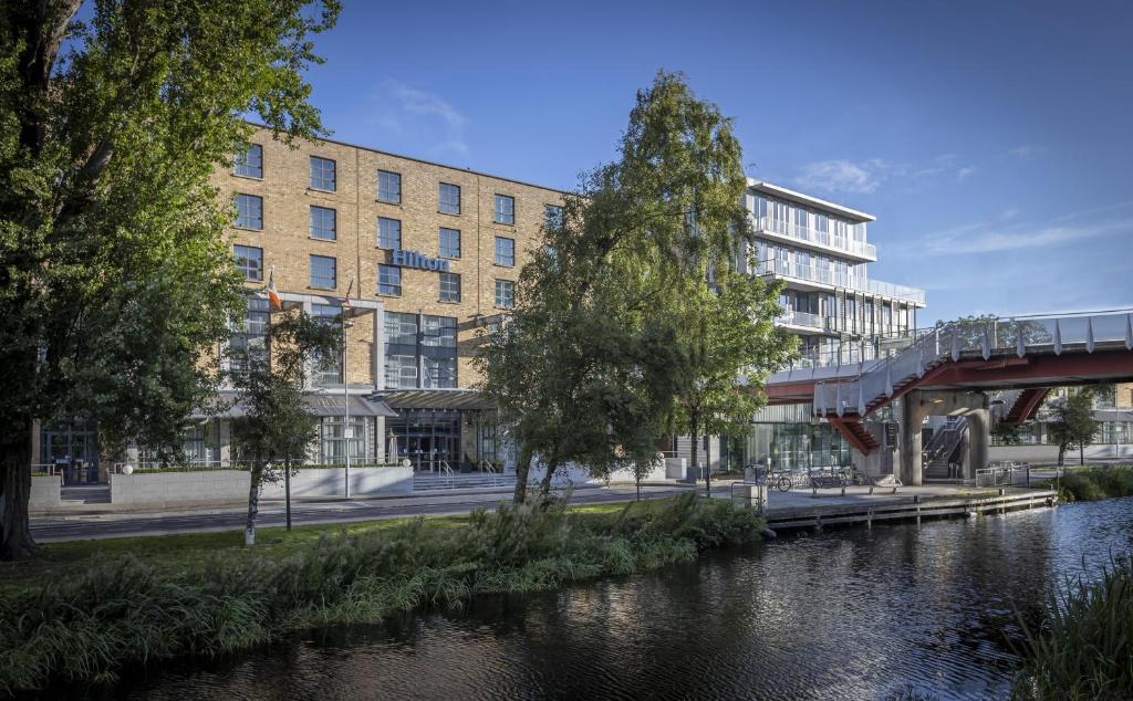 a rendering of a building next to a river at Hilton Dublin in Dublin