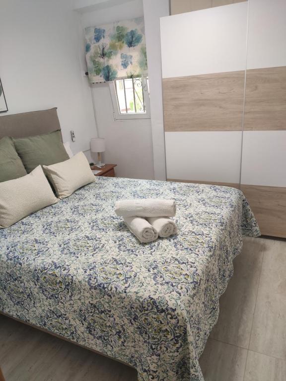 a bedroom with a bed with two towels on it at Casita La Playa in Málaga