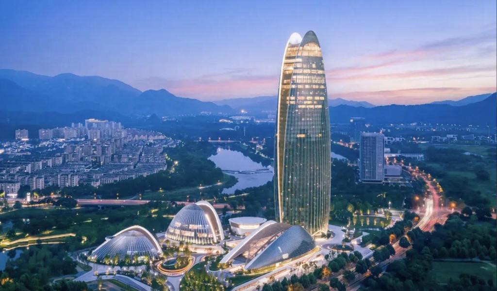 a tall building with lights on it in a city at Sofitel Anji in Huzhou