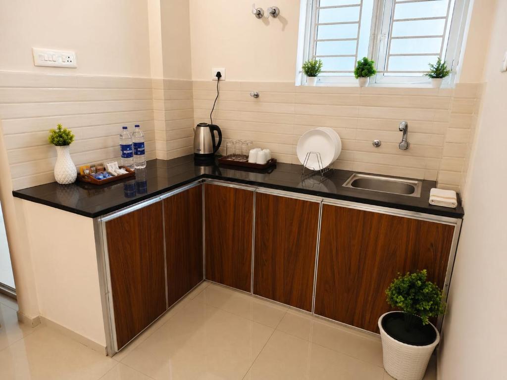 a kitchen with a sink and a counter top at Govindha bhavanam 150 meters from Guruvayur temple in Guruvāyūr