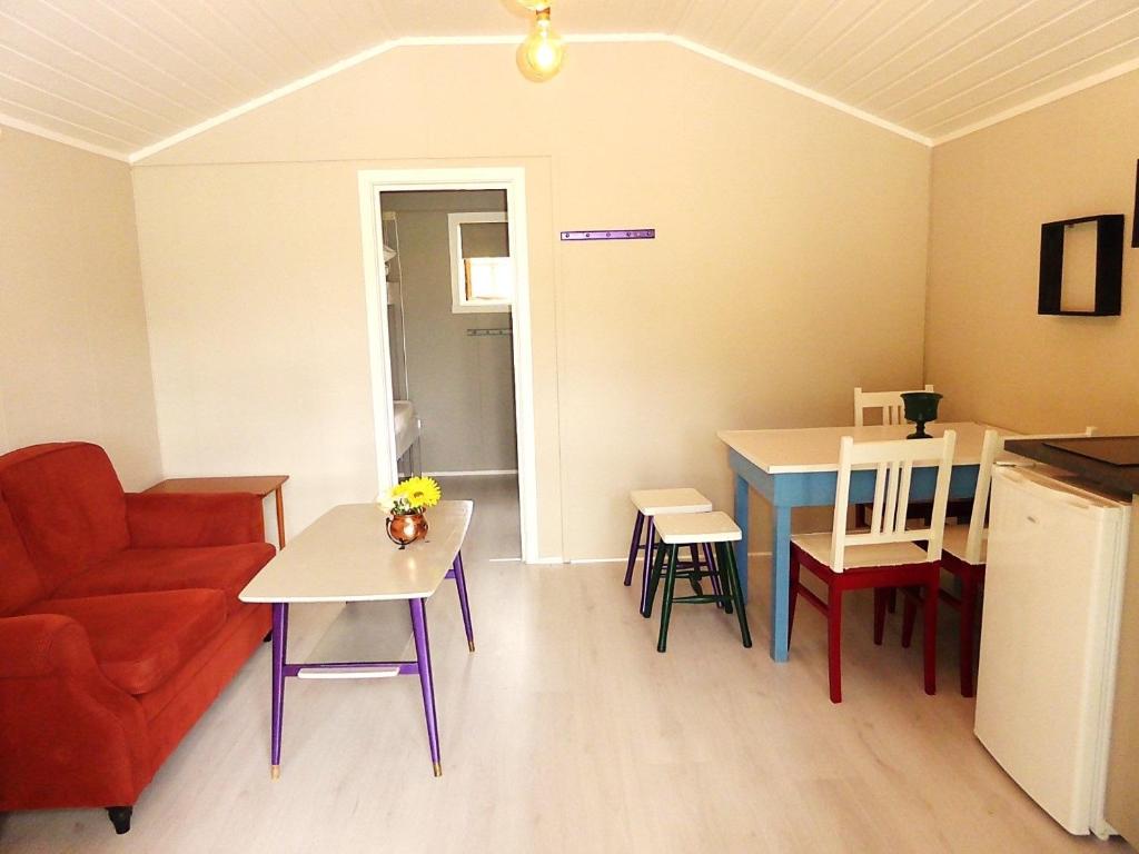 a living room with a couch and a table at Sona Camping in Hegra