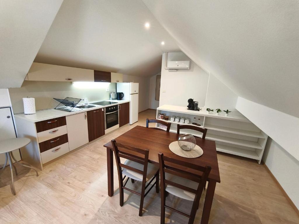 a kitchen and dining room with a table and chairs at Apartment Cankar's View in Vrhnika