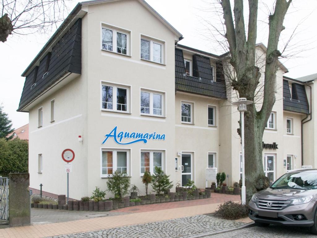 a large white building with a sign on it at Bansin, Aquamarina WG 10 in Bansin