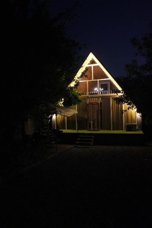a house with lights on the side of it at night at Family House Quba, Guba, Qeçreş,Qəçrəş,Qecresh in Qǝçrǝş