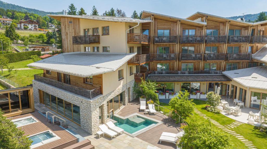 an aerial view of a house with a swimming pool at Blu Hotel Natura & Spa - Adults Only in Folgaria