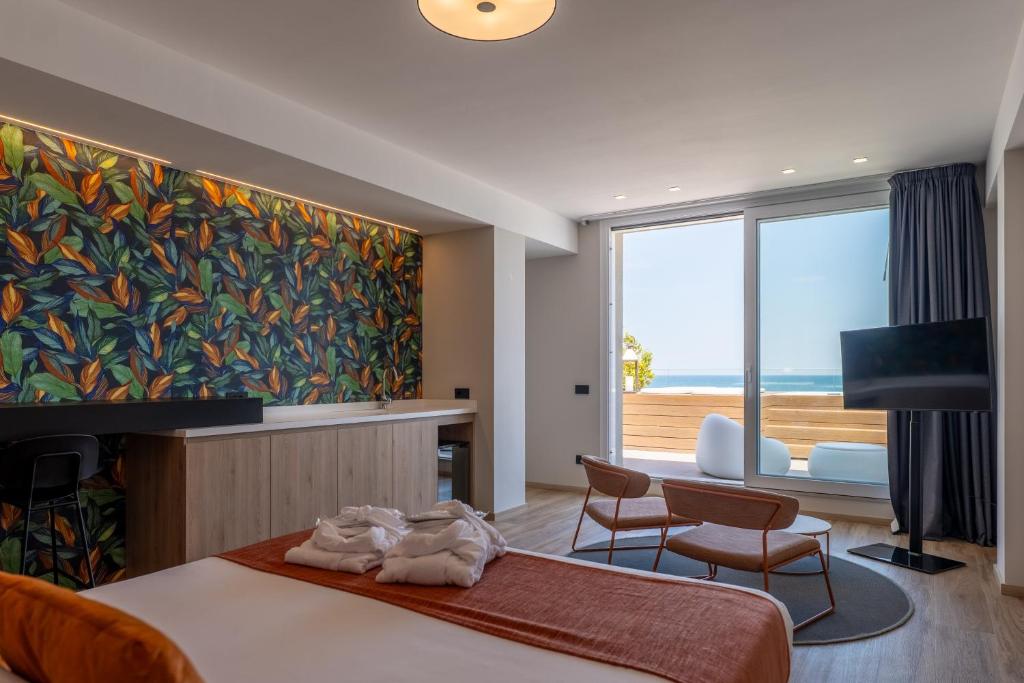 a bedroom with a large painting on the wall at Hotel Sporting Riccione in Riccione
