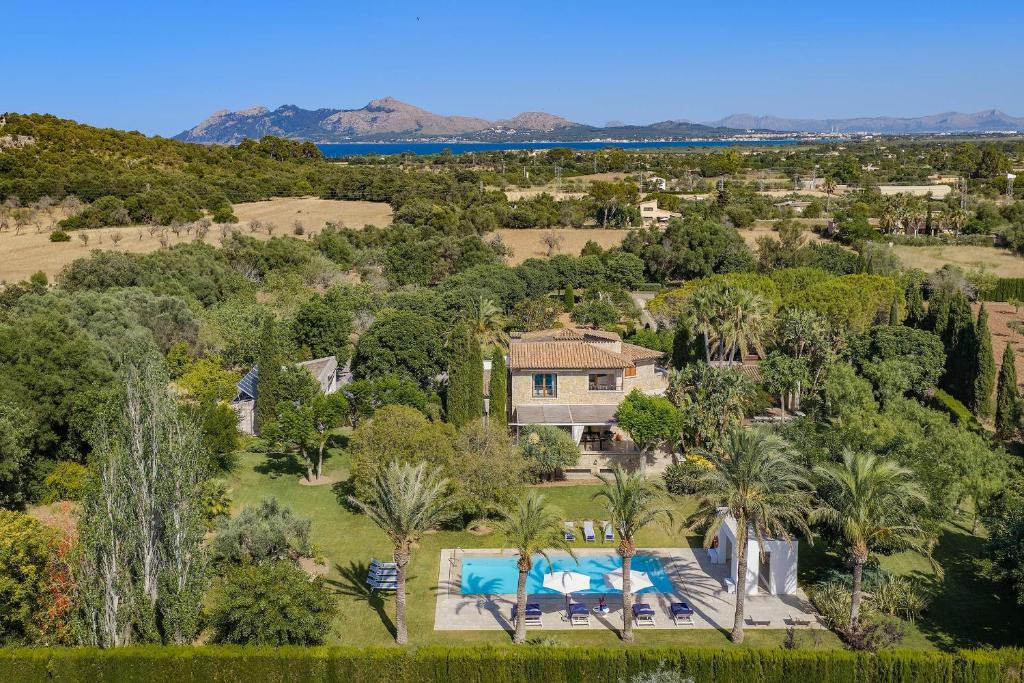 an aerial view of a house with a pool and trees at Finca Playa Llenaire - Can Pou in El Port