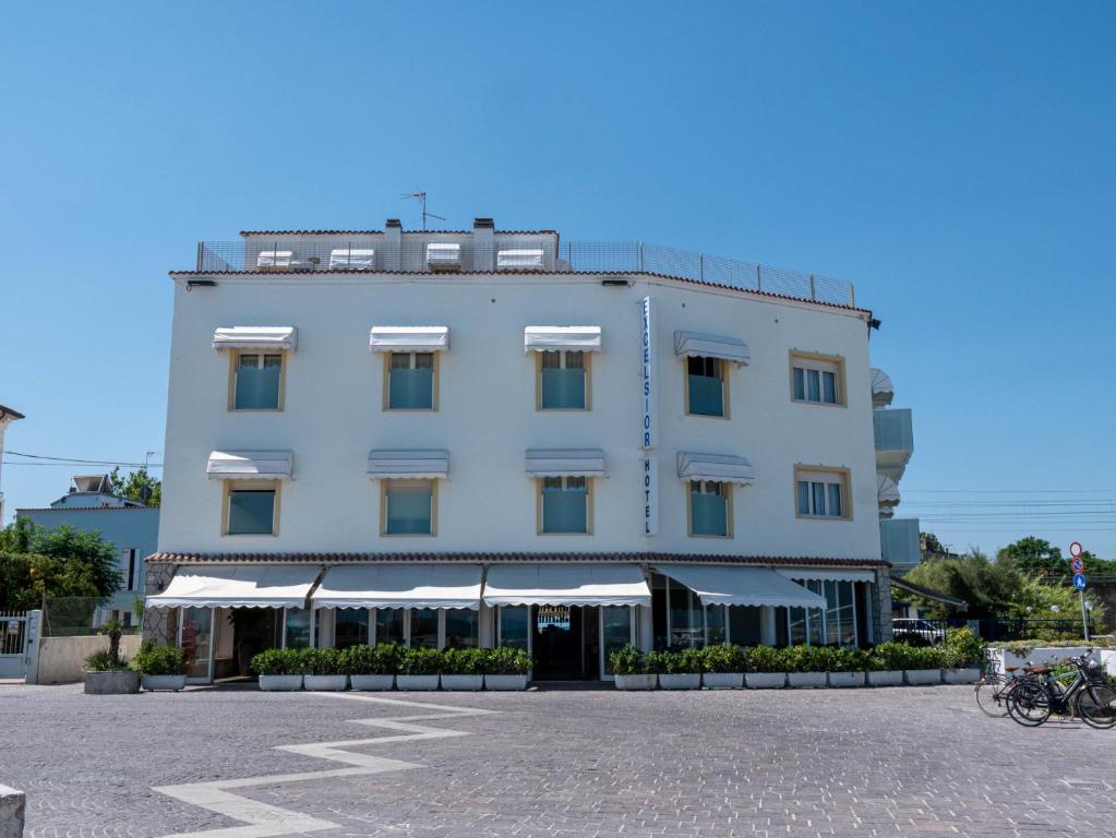 a large white building with a lot of windows at Hotel Excelsior in Fano