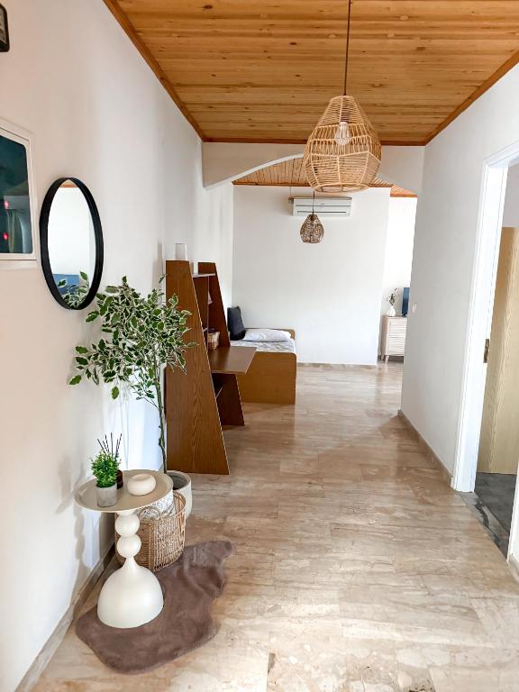 a living room with a table and a mirror at Sea View House B in Péra Mélana