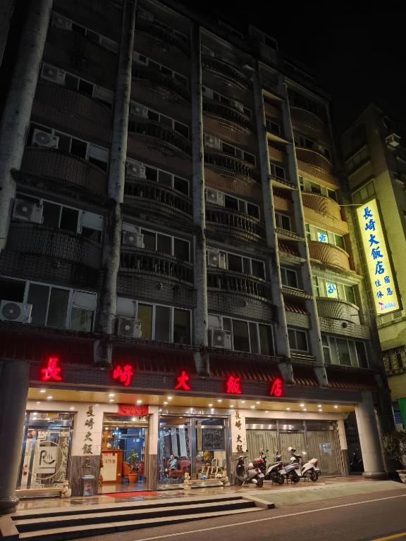 a building with two motorcycles parked in front of it at Longchi Hot-Spring Hotel in Jiaoxi