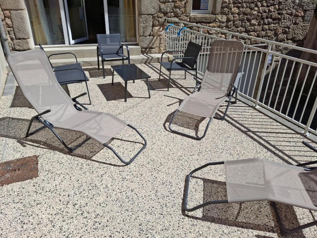 a group of chairs and a table on a patio at La belle étoile in Saugues