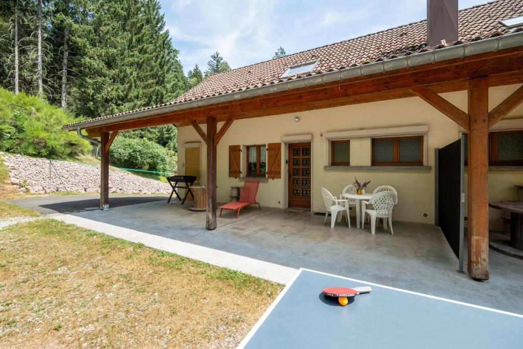 a covered patio with a table and chairs at Appartement 5 - La Petite Caille in Plombières-les-Bains