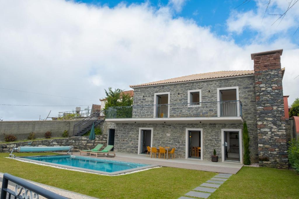 a villa with a swimming pool and a house at Ponta do Pargo Village - By WeHostMadeira in Ponta do Pargo