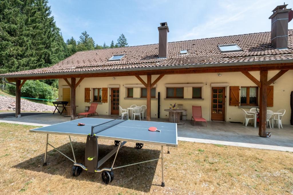 a ping pong table in front of a house at La Petite Caille - Appartement 4 in Plombières-les-Bains